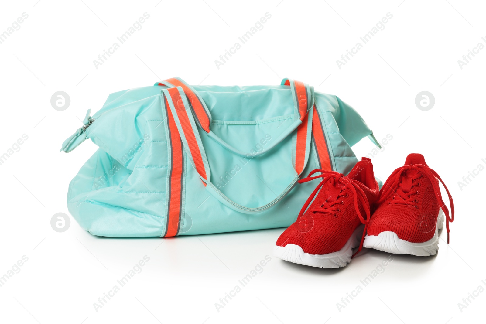 Photo of Stylish sports bag and sneakers isolated on white