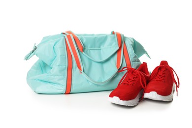 Photo of Stylish sports bag and sneakers isolated on white