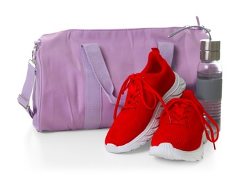 Photo of Stylish sports bag, sneakers and bottle isolated on white