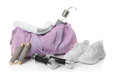 Photo of Stylish gym bag with sports equipment, towel, bottle and sneakers isolated on white
