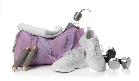 Photo of Stylish gym bag with sports equipment, towel, bottle and sneakers isolated on white