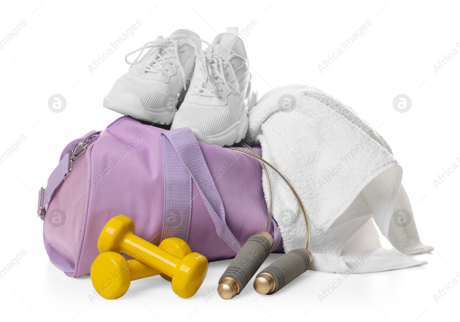 Photo of Stylish sports bag with sneakers, towel, skipping rope and dumbbells isolated on white