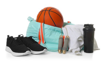 Photo of Stylish gym bag with sports equipment, towel, shaker cup and sneakers isolated on white