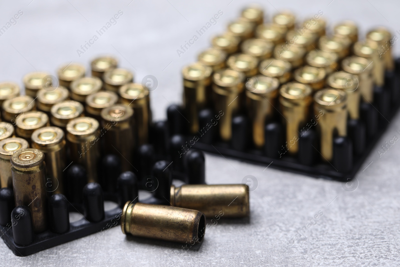Many metal bullets on grey table, closeup Photo of Many metal bullets on grey table, closeup