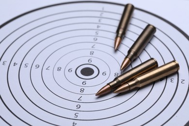 Photo of Many metal bullets on shooting target, closeup