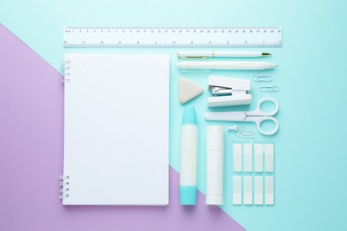 Photo of White notepad and other stationery on color background, flat lay. Space for text