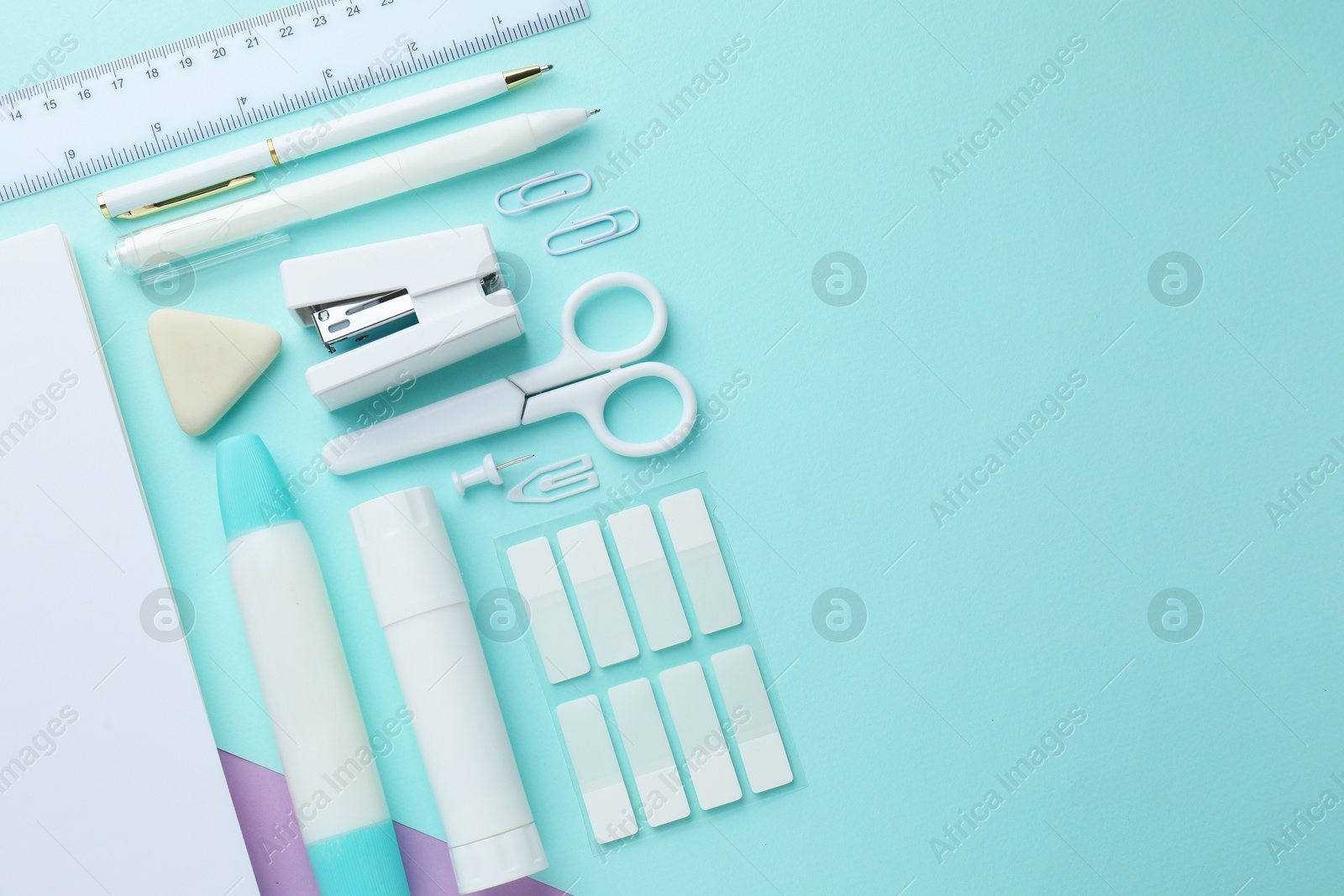 Different white stationery on color background, flat lay. Space for text Photo of Different white stationery on color background, flat lay. Space for text