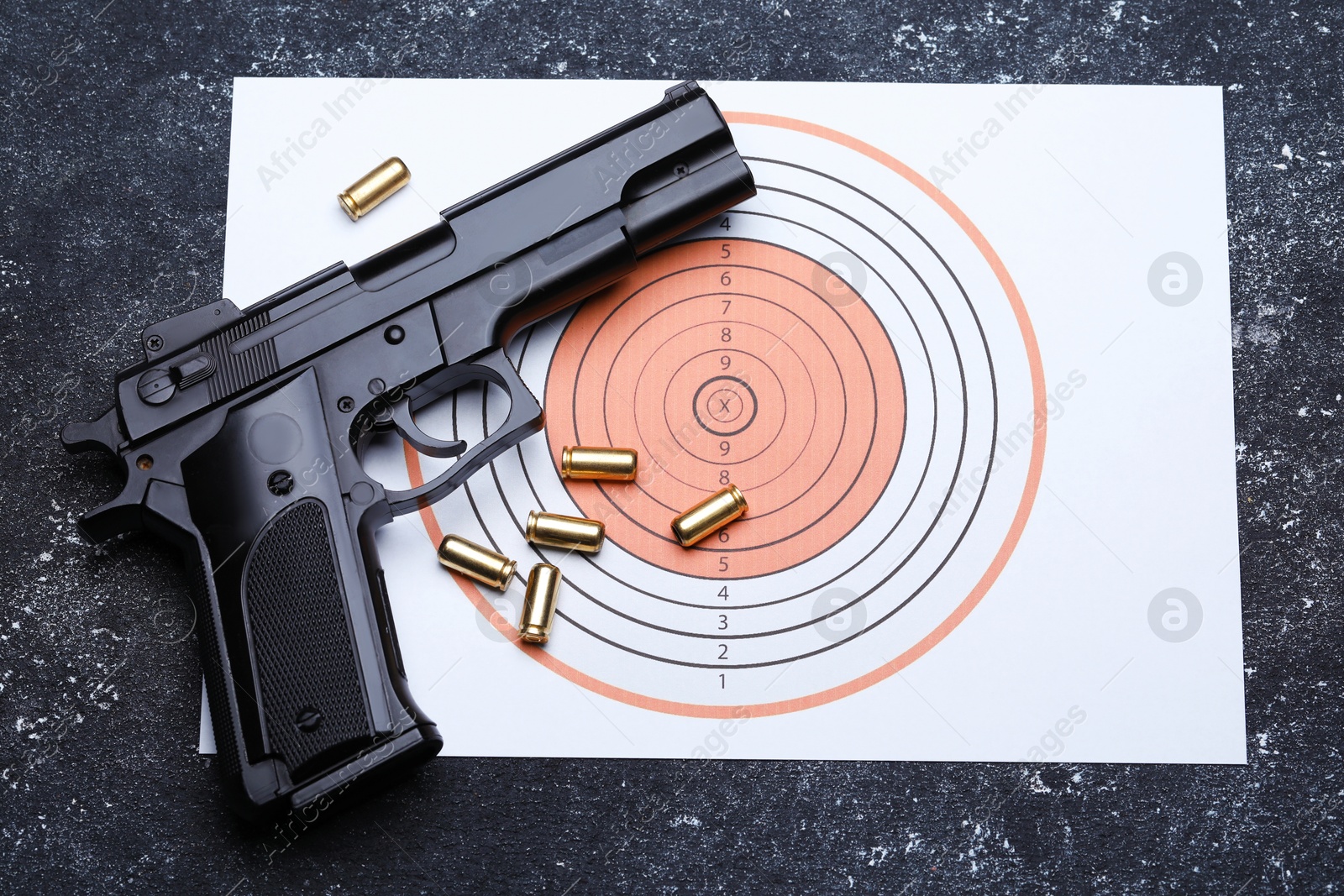 Many metal bullets, gun and shooting target on grey table, flat lay Photo of Many metal bullets, gun and shooting target on grey table, flat lay