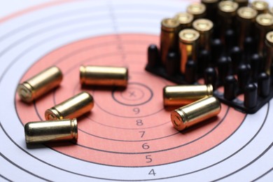 Photo of Many metal bullets on shooting target, closeup