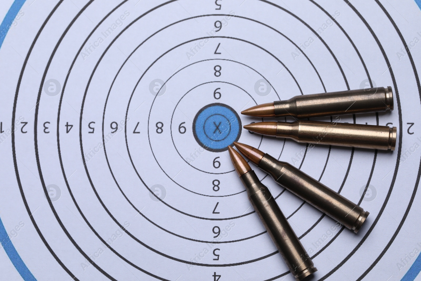 Many metal bullets on shooting target, flat lay Photo of Many metal bullets on shooting target, flat lay
