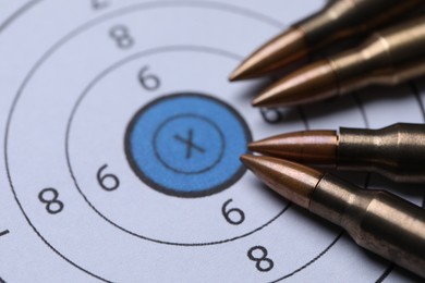 Photo of Many metal bullets on shooting target, closeup