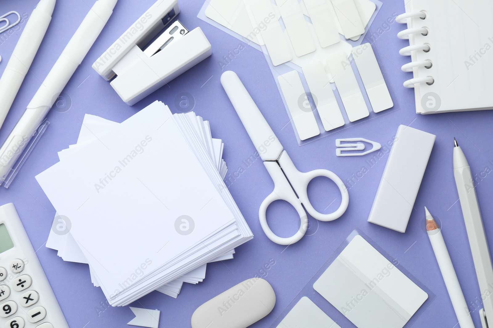 Photo of Different white stationery on violet background, flat lay