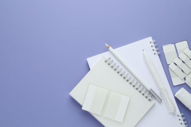 Photo of Different white stationery on violet background, flat lay. Space for text