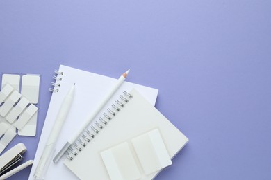 Photo of Different white stationery on violet background, flat lay. Space for text