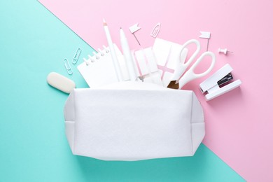 Photo of White pencil case and different stationery on color background, flat lay