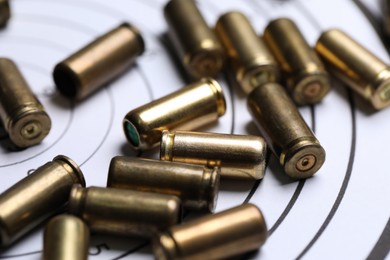 Photo of Many metal bullets on shooting target, closeup