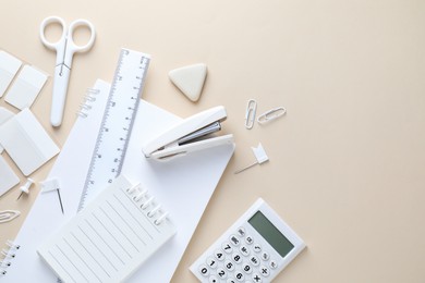 Photo of Different white stationery on beige background, flat lay. Space for text