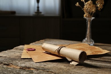 Photo of Old paper scrolls on wooden table, closeup