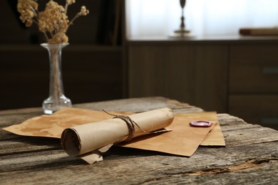 Photo of Old paper scrolls on wooden table, closeup