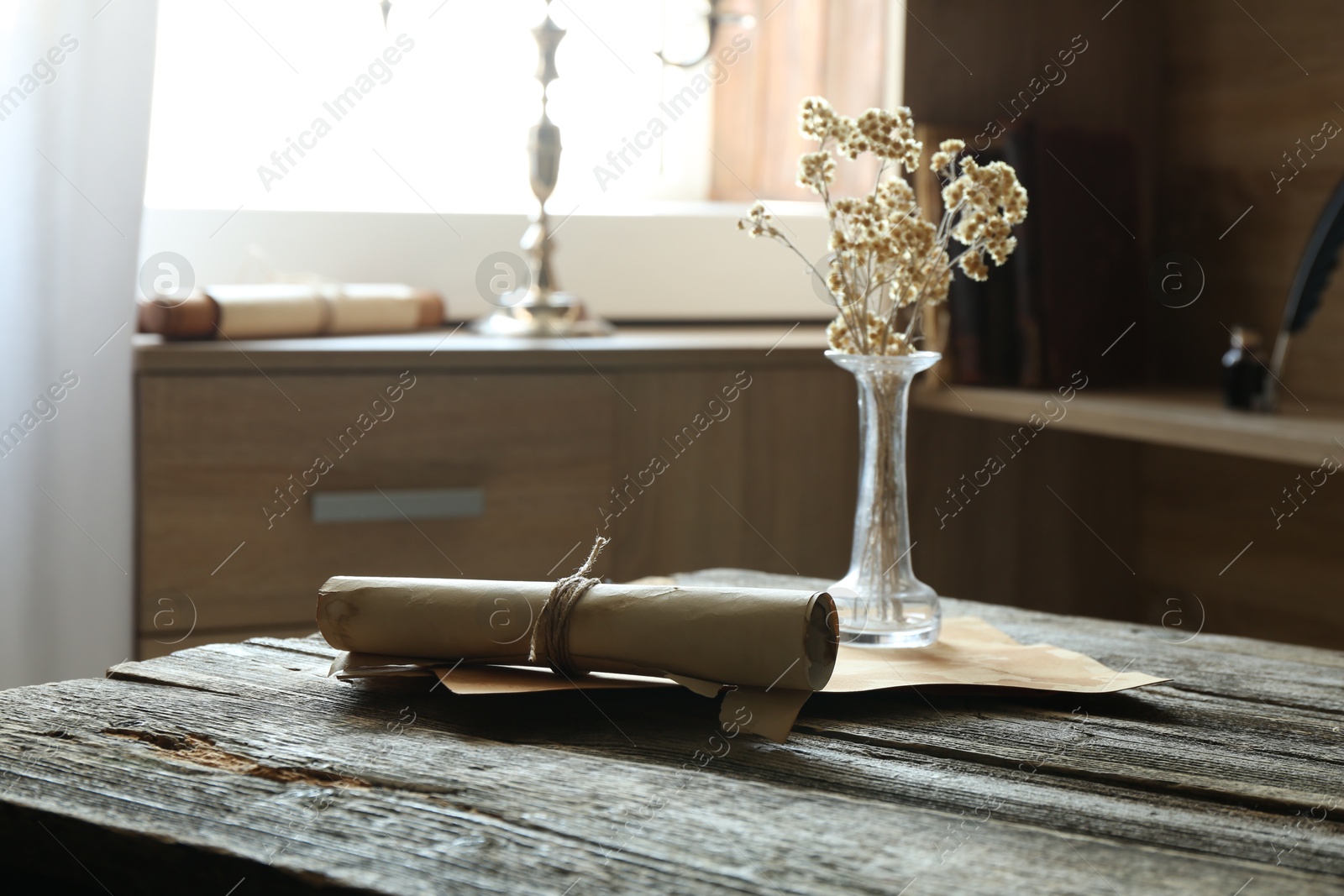 Old paper scrolls and sheets on wooden table Photo of Old paper scrolls and sheets on wooden table