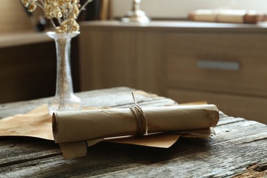Photo of Old paper scrolls on wooden table, closeup