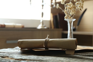 Photo of Old paper scrolls on wooden table, closeup