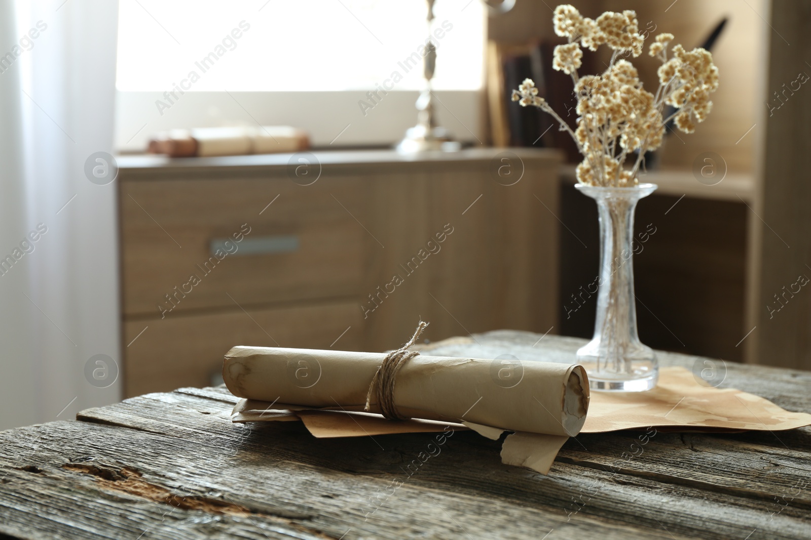 Old paper scrolls and sheets on wooden table Photo of Old paper scrolls and sheets on wooden table