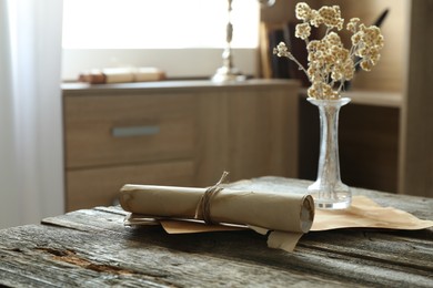 Photo of Old paper scrolls and sheets on wooden table