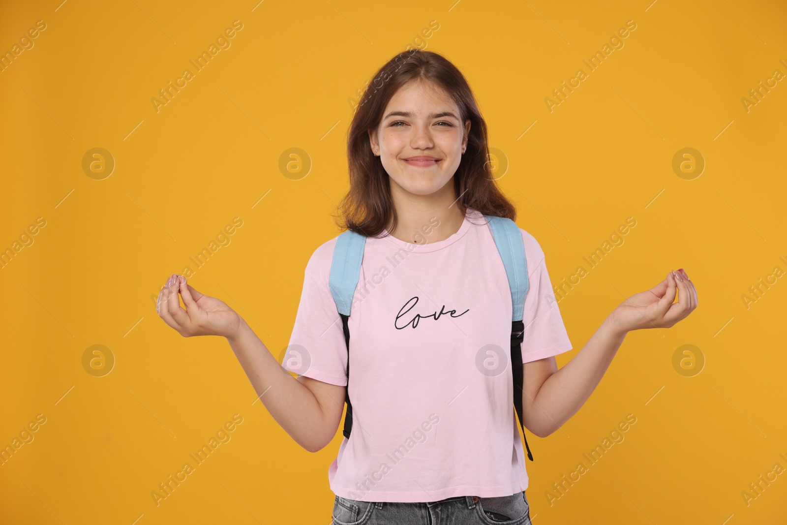 Student meditating before exam on orange background Photo of Student meditating before exam on orange background