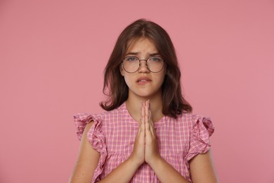 Photo of Student praying for good exam result on pink background