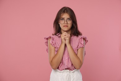 Photo of Student praying for good exam result on pink background