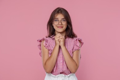 Photo of Student praying for good exam result on pink background