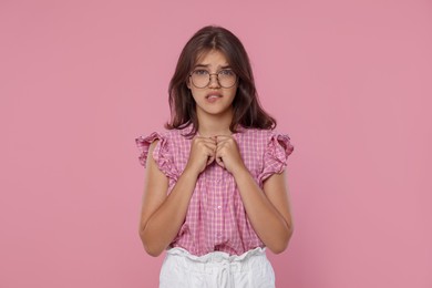 Photo of Student praying for good exam result on pink background