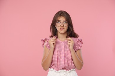 Photo of Student crossing fingers on pink background. Hope for good exam result