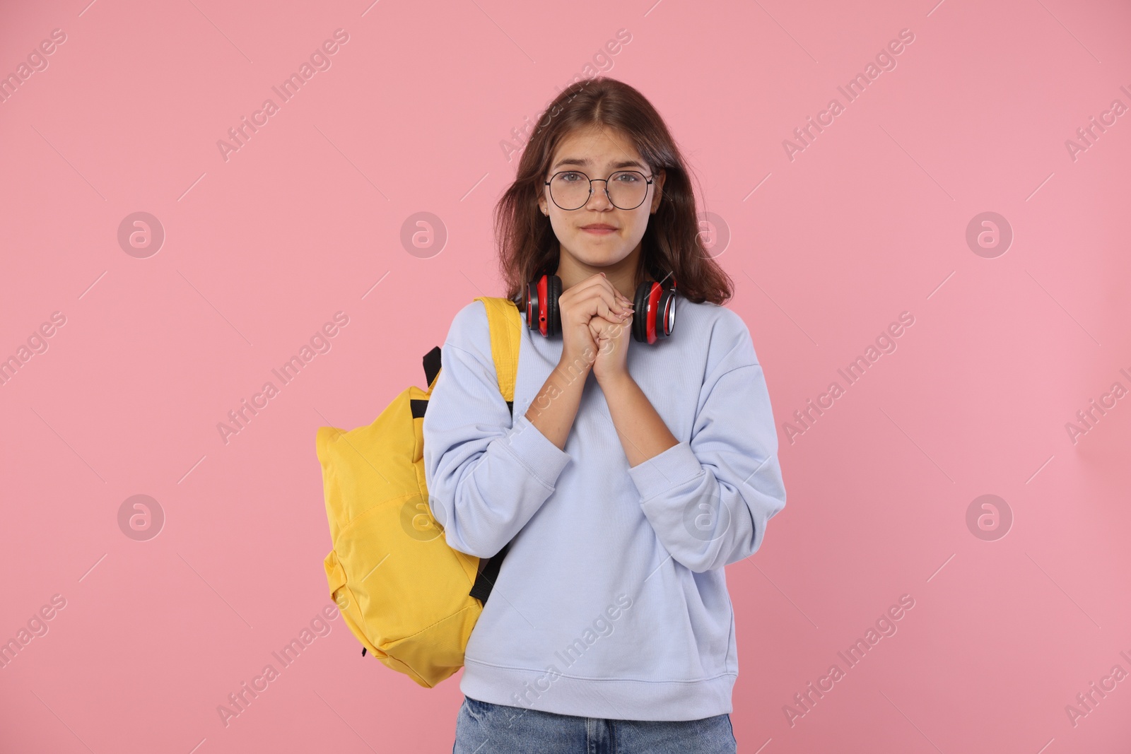 Student praying for good exam result on pink background Photo of Student praying for good exam result on pink background
