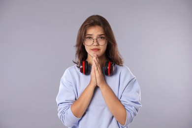 Photo of Student praying for good exam result on gray background