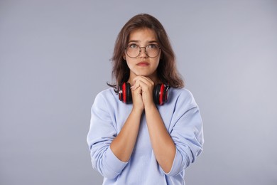 Photo of Student praying for good exam result on gray background