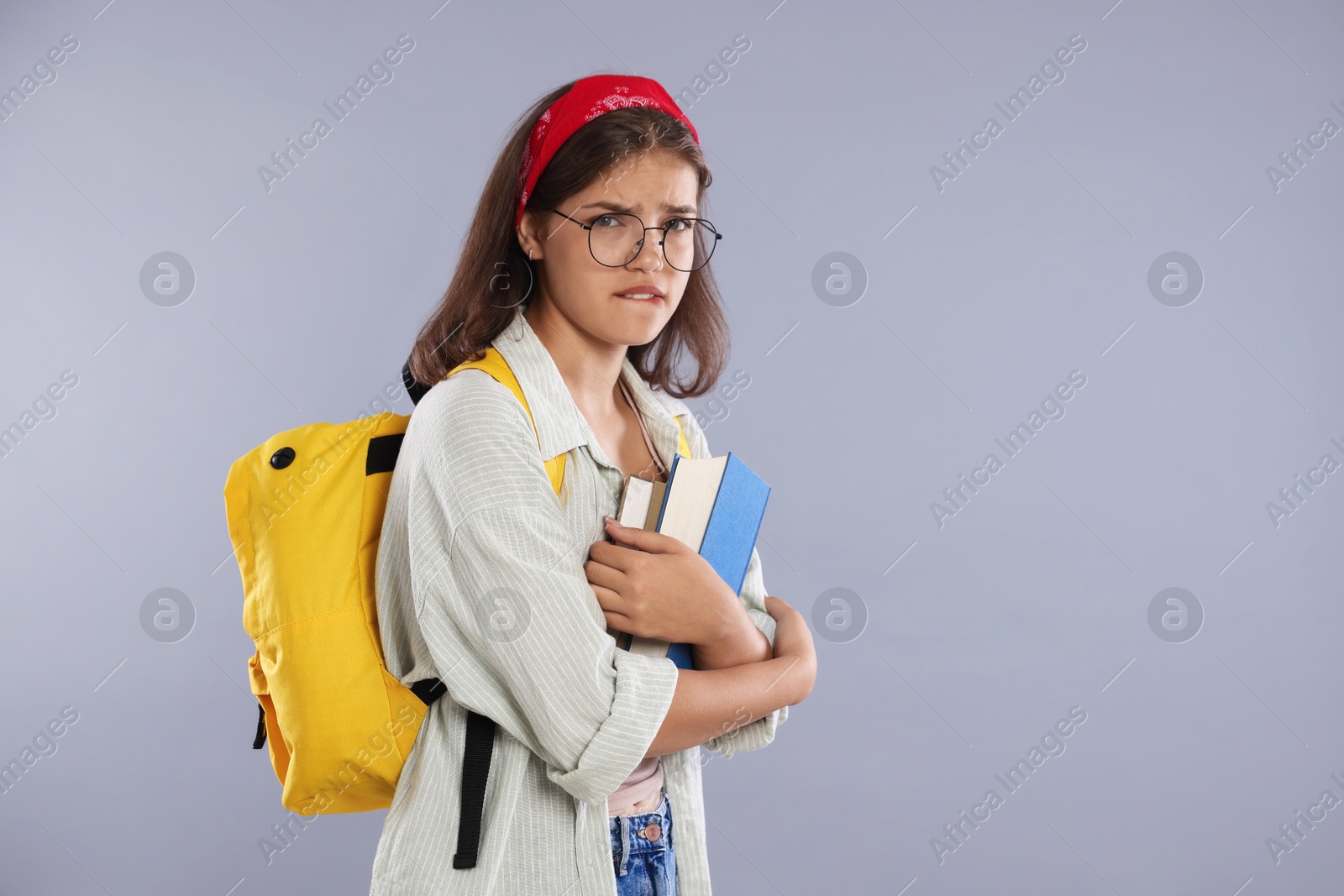 Student worried about her exam result on gray background. Space for text Photo of Student worried about her exam result on gray background. Space for text