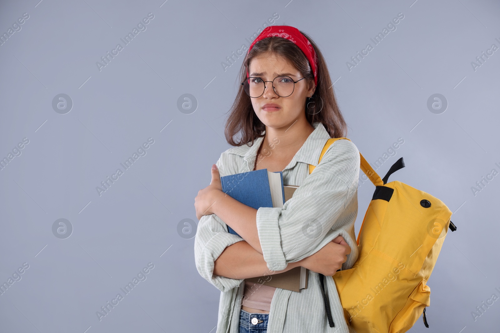 Student worried about her exam result on gray background. Space for text Photo of Student worried about her exam result on gray background. Space for text