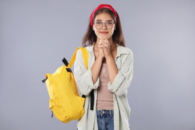 Photo of Student praying for good exam result on gray background