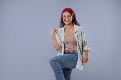 Photo of Student feeling happy about her good exam result on gray background