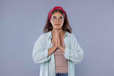 Photo of Student praying for good exam result on gray background