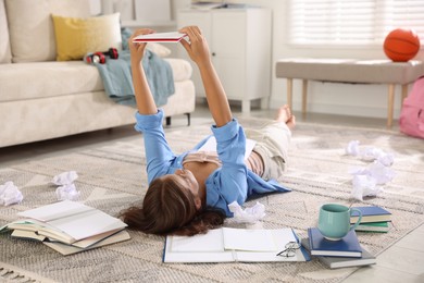 Photo of Student preparing for exam on rug indoors