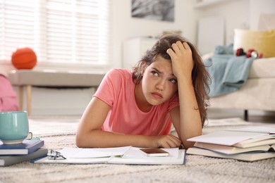 Photo of Tired student preparing for exam at home
