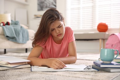 Photo of Tired student preparing for exam at home