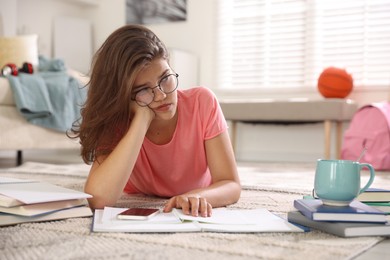 Photo of Tired student preparing for exam at home