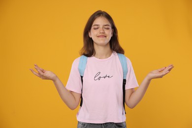 Photo of Student meditating before exam on orange background