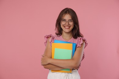 Photo of Student feeling happy about her good exam result on pink background