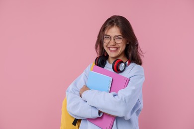 Photo of Student feeling happy about her good exam result on pink background