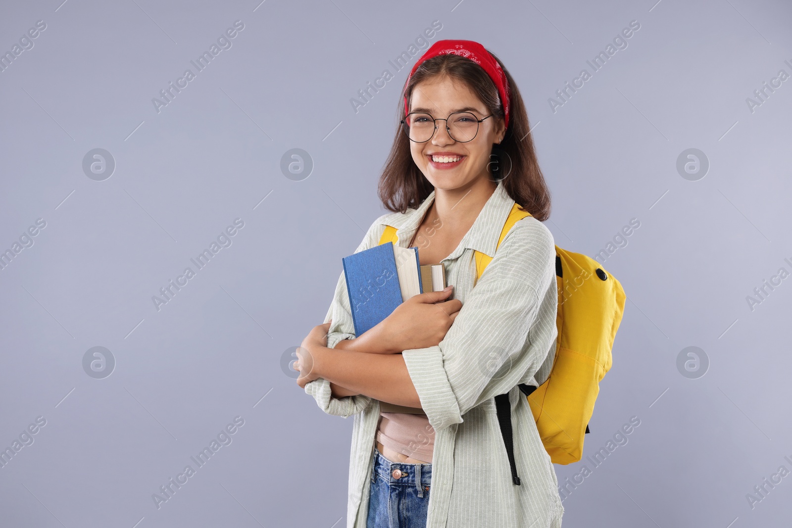 Student feeling happy about her good exam result on gray background. Space for text Photo of Student feeling happy about her good exam result on gray background. Space for text